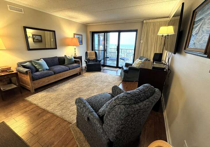 Interior Living Space With Sofas, Rug, And Balcony View