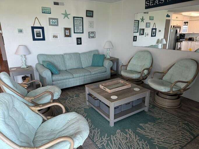 Seaside-themed Sitting Room With Sea-green Sofa, Matching Chairs, And Coastal Decor