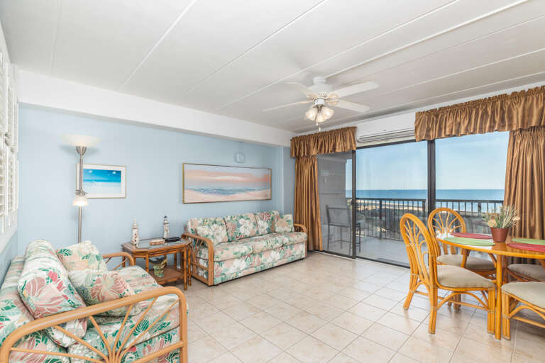 Seaside Seating In Sunny Vacation Rental Space With Balcony View