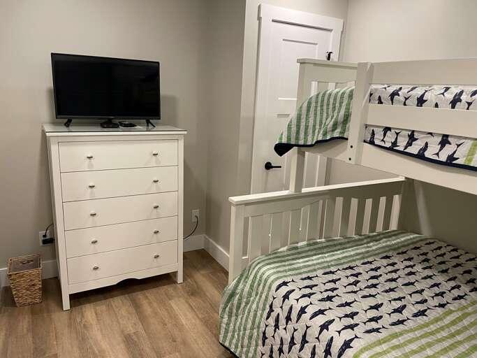 This guest bedroom has a full sized bed and twin XL above.  Perfect for 3 children or a family.  
Plenty of storage along with flat screen TV. 