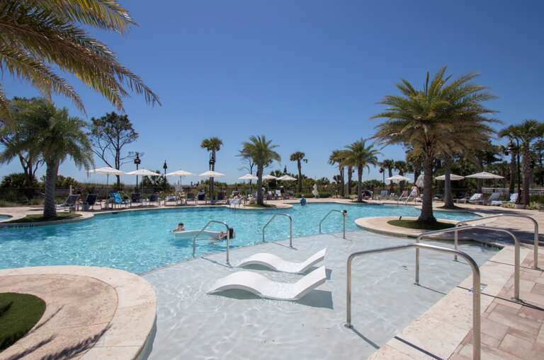 Imagine relaxing by the palm trees or umbrellas in this great pool! 