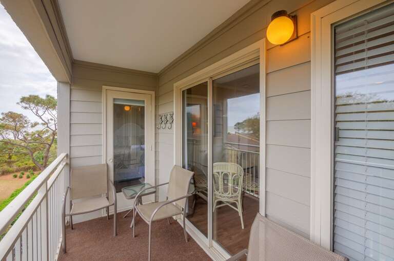 Balcony has 4 chairs and lovely view from 3rd floor. 