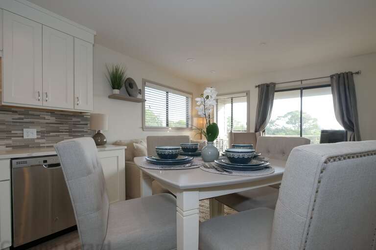 Dining and Kitchen area with beautiful backsplash and all upgraded stainless steel appliance.