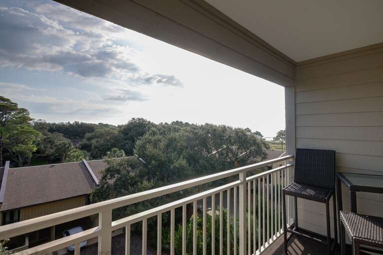 Balcony offers two small tall tables and four chairs with a relaxing view of the atlantic ocean . 