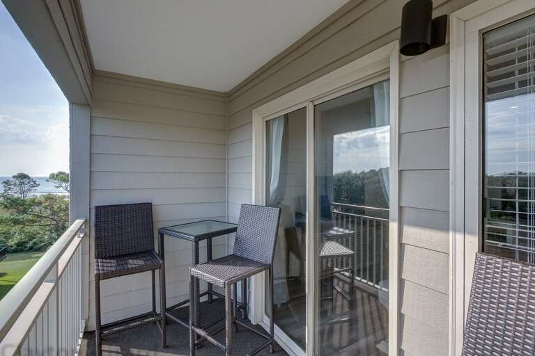Balcony with chairs/table and a relaxing view of the Atlantic ocean.