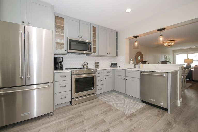 The fully-equipped and newly designed kitchen features new appliances as well as dishes, glasses, cookware, and utensils.