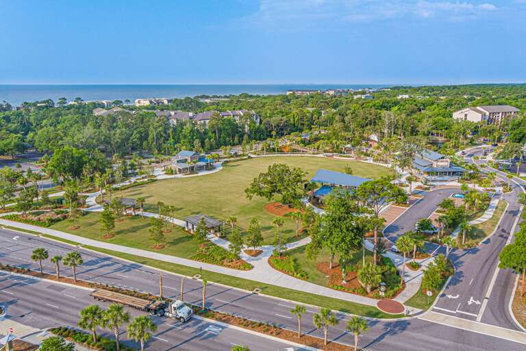 Aerial View Of A Park With A Pond And Surrounding Road