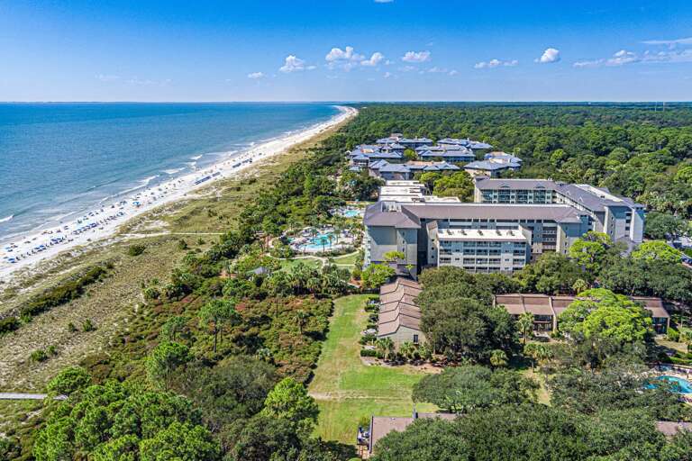 Aerial View Of A Beachfront Vacation Rental Complex Near The Ocean