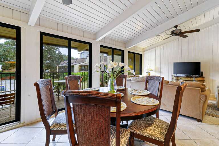 Dining Area In Vacation Rental With Table, Chairs, And TV