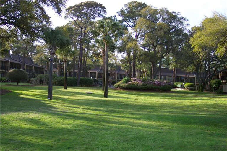 This view is of the lawn  on the oceanside of the property looking from the beach and dune back to the condos.
