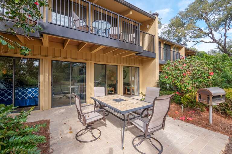 The ground level patio features a dining table with seating for four or more and a built in charcoal grill.  The ground level patio features a dining table with seating for four or more and a built in charcoal grill.