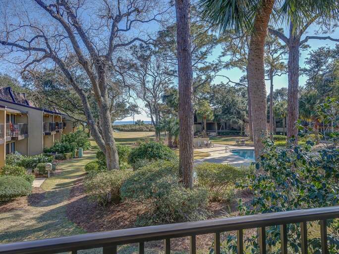 Beautiful view from the mid-level balcony of the pool, grounds and ocean! 
