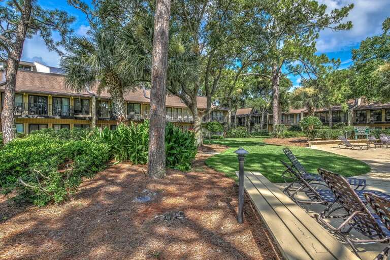 Relax in the dappled sunshine at the pool/courtyard area of the Hilton Head Beach Villa complex