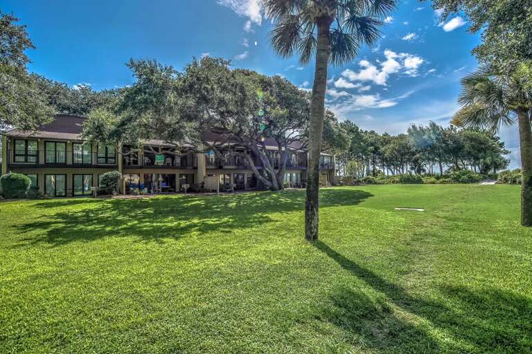 Lovely grounds of the Hilton Head Beach Villa Complex in the springtime showing new growth on ancient Oak trees, Palmetto trees and pine trees. 