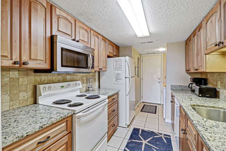 Fully equipped modern kitchen with granite countertops and all major appliances .  Regular drip coffeemaker and toaster oven.   