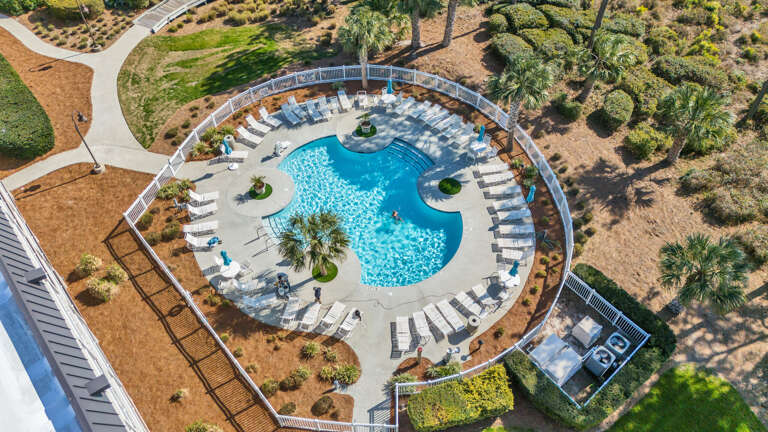 Aerial View Of Outdoor Swimming Pool With Sun Loungers And Surrounding Garden