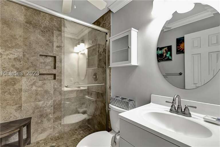 Beautiful tiled walk-in shower in this updated bathroom.