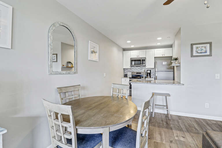 Just steps from the living area, our bright and inviting dining space offers the perfect setting for shared meals and moments of relaxation. The elegant dining table comfortably seats 4 guests and is framed by wide windows that showcase sweeping views of 