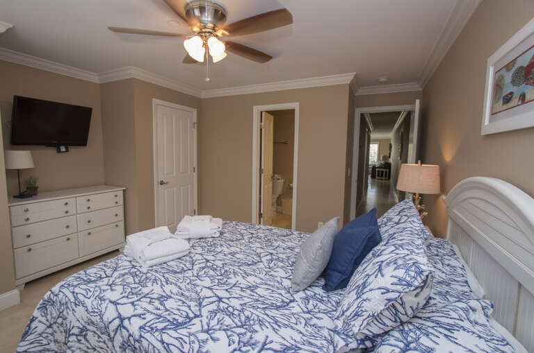 Master Bedroom fully furnished in Ocean Dunes features a Queen sized bed, Smart flat screen T.V, closet space and a private Bath.