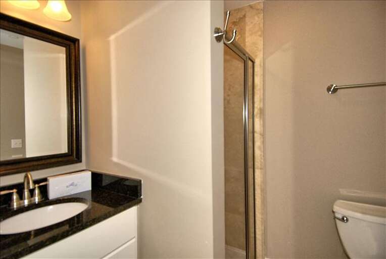  Renovated guest bathroom with beautiful granite countertop sink  and walk in shower.