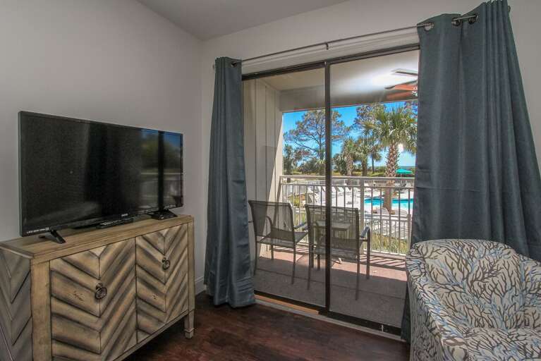  Living room offers comfy sofa bed, wall mounted smart flat screen T.V. and sliding door to balcony with amazing Beachfront view and Palm trees.