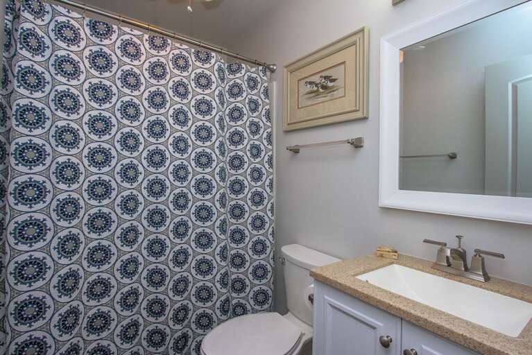 The bathroom in this one bedroom condo has a tub/shower combination.  The vanity has a granite top.