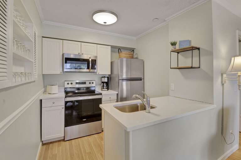 New appliances and countertops in this open, bright, white kitchen 