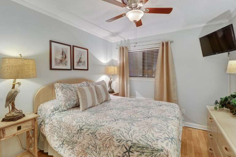 Queen sized bedroom and large wall mounted TV. 