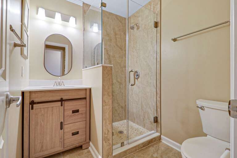 New walk-in shower, vanity and lighting in guest bathroom.
