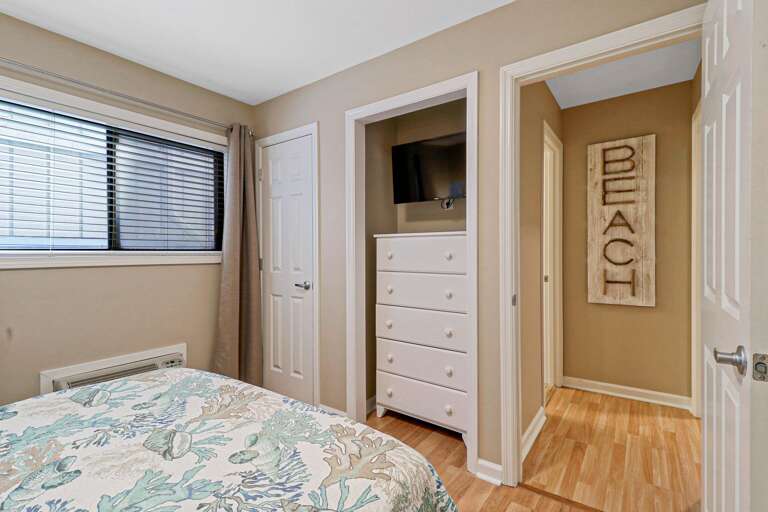 Plenty of storage in this guest bedroom along with wall mounted flat screen TV. 