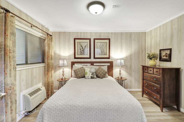 Nicely decorated queen sized bedroom with new flooring and individual A/C unit. 