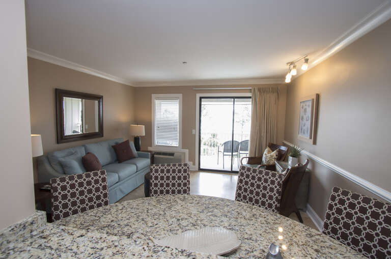 The newly renovated Kitchen / Dining Area features all stainless appliances, granite counters and dining bar having seating for four, and tile flooring throughout.