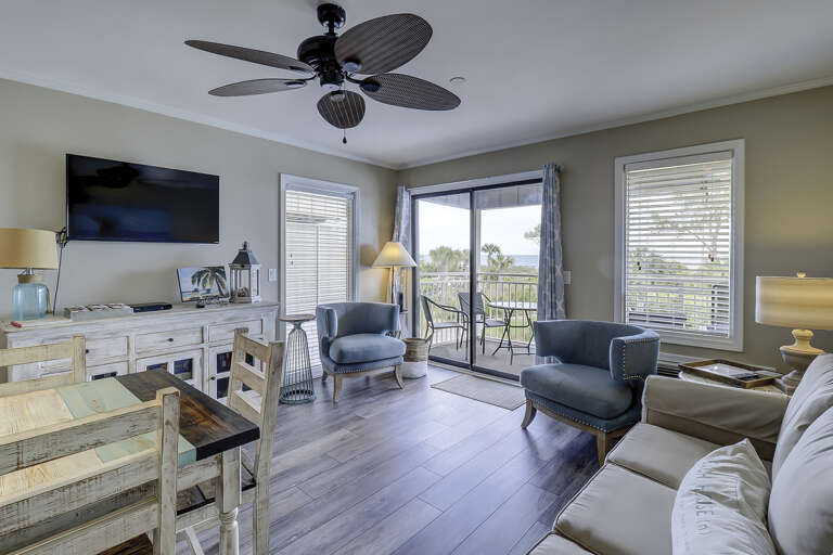 Living Area With Balcony Access In A Vacation Rental