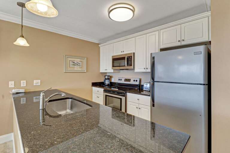 The beautiful, upgraded kitchen has stainless steel appliances and granite counter tops.