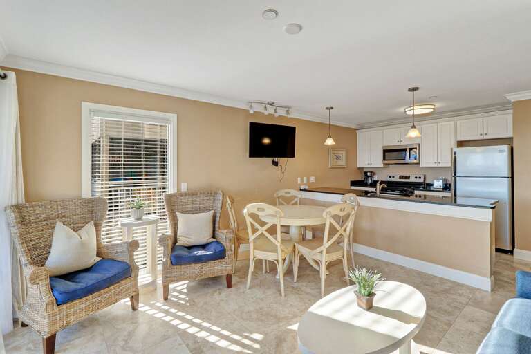 Updated living area has tile flooring and decorative furniture.