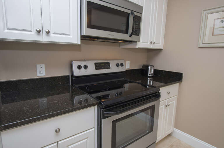 The newly renovated Kitchen / Dining Area features all stainless appliances, granite counters and dining bar having seating for four, and tile flooring throughout.