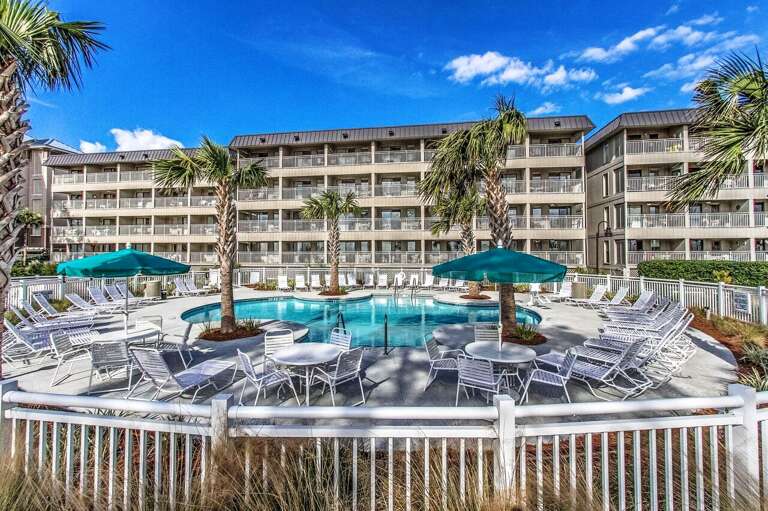 View of Ocean Dunes pool with umbrellas, tables and chairs. 