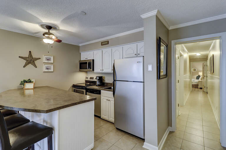 The newly renovated Kitchen / Dining Area features all stainless appliances, granite counters and dining bar having seating for four, and tile flooring throughout.