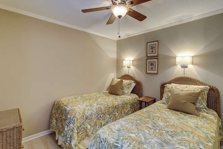 Nicely furnished guest room with twin beds. 