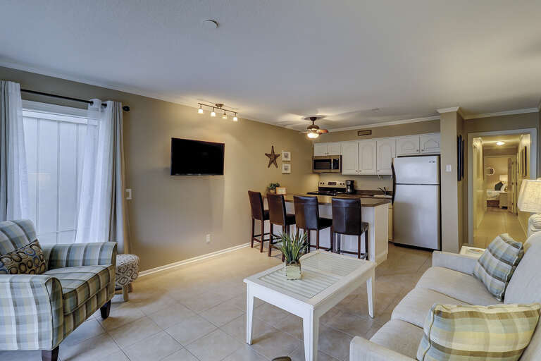 The beautiful kitchen /  dining area features all stainless appliances, granite counters and dining bar having seating for four, and tile flooring throughout.