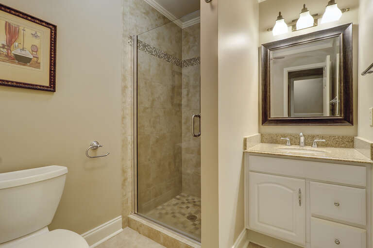 Guest bathroom with walk-in tiled shower. 