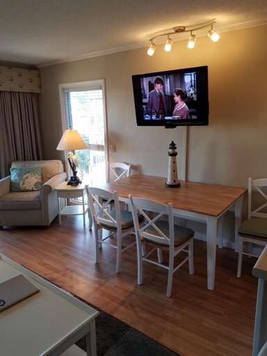 Dining area and flat screen TV in living room
