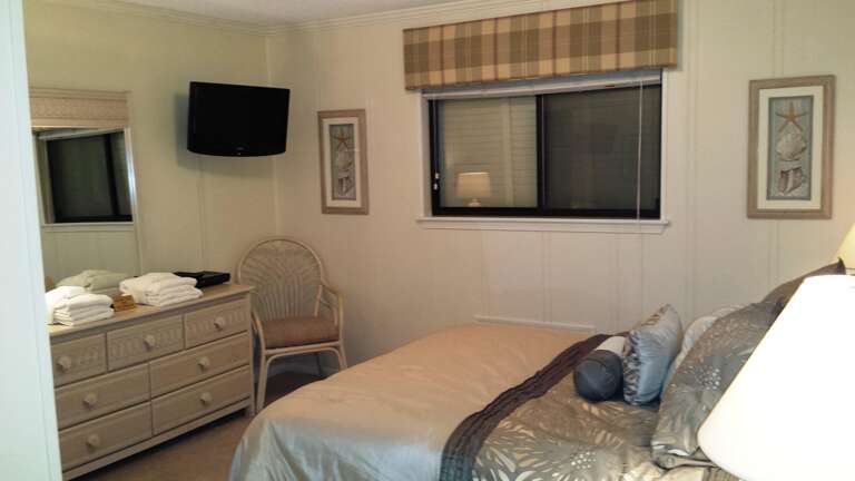 Master bedroom features a queen sized bed and a new flat screen television.