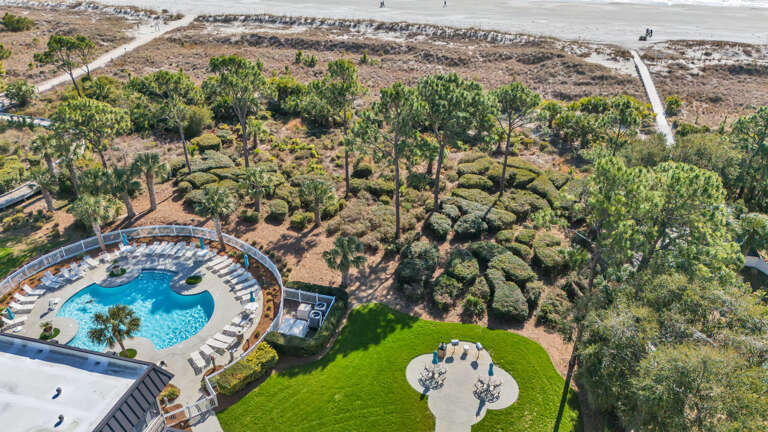Aerial View Of A Beachside Property With Pool And Palm Trees