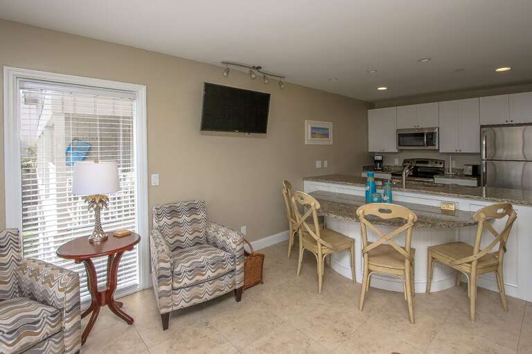 The newly renovated Kitchen / Dining Area features all stainless appliances, granite counters and dining bar having seating for four, and tile flooring throughout.

