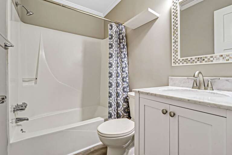 Beautiful bright and newly painted bathroom with shower/tub combination and new vanity. 