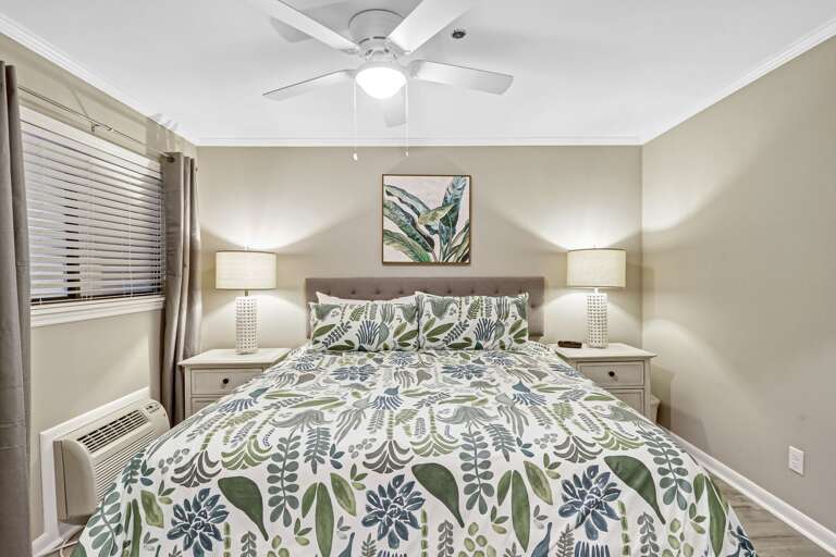 Newly painted decorated bedroom with new king sized bed, ceiling fan and individual A/C unit. 