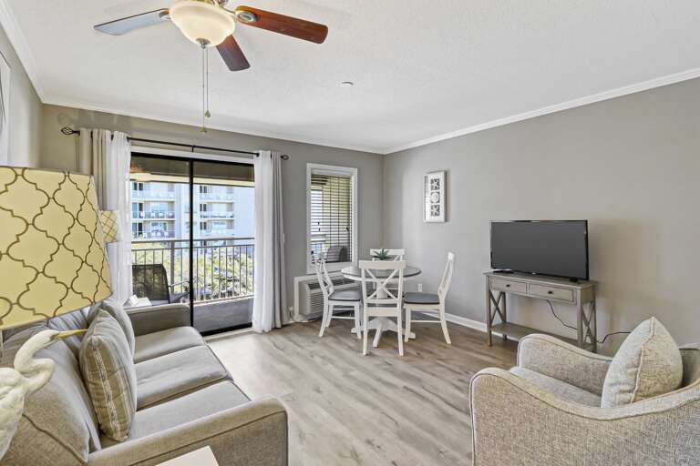 Enjoy watching large flat screen TV in this lovely renovated villa with new, comfortable sofa and chair.  Easy access to the balcony.  