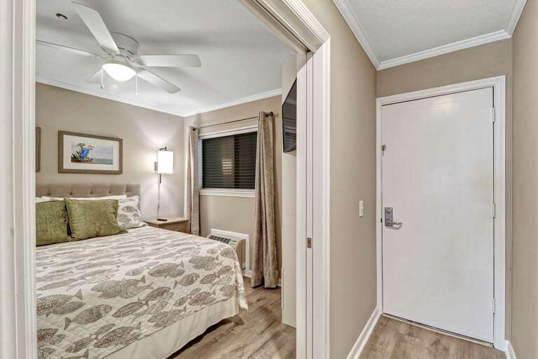 King sized bedroom just off the entryway to this renovated 1 bedroom villa. 