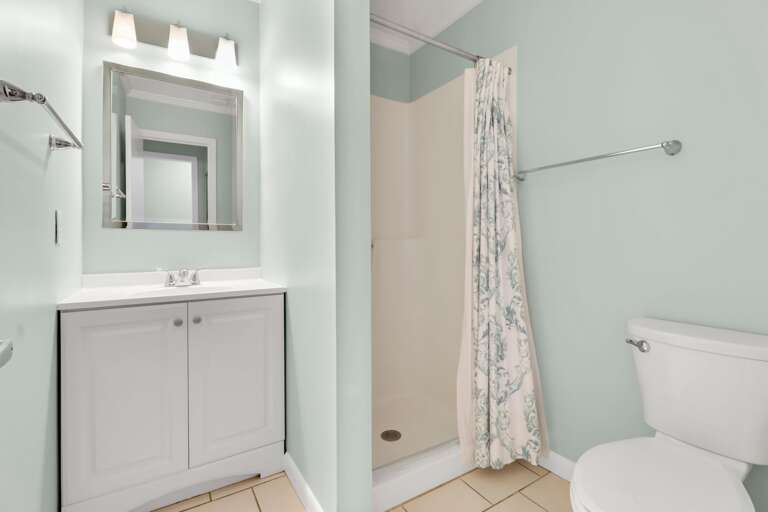 Freshly painted guest bathroom has a walk-in shower.